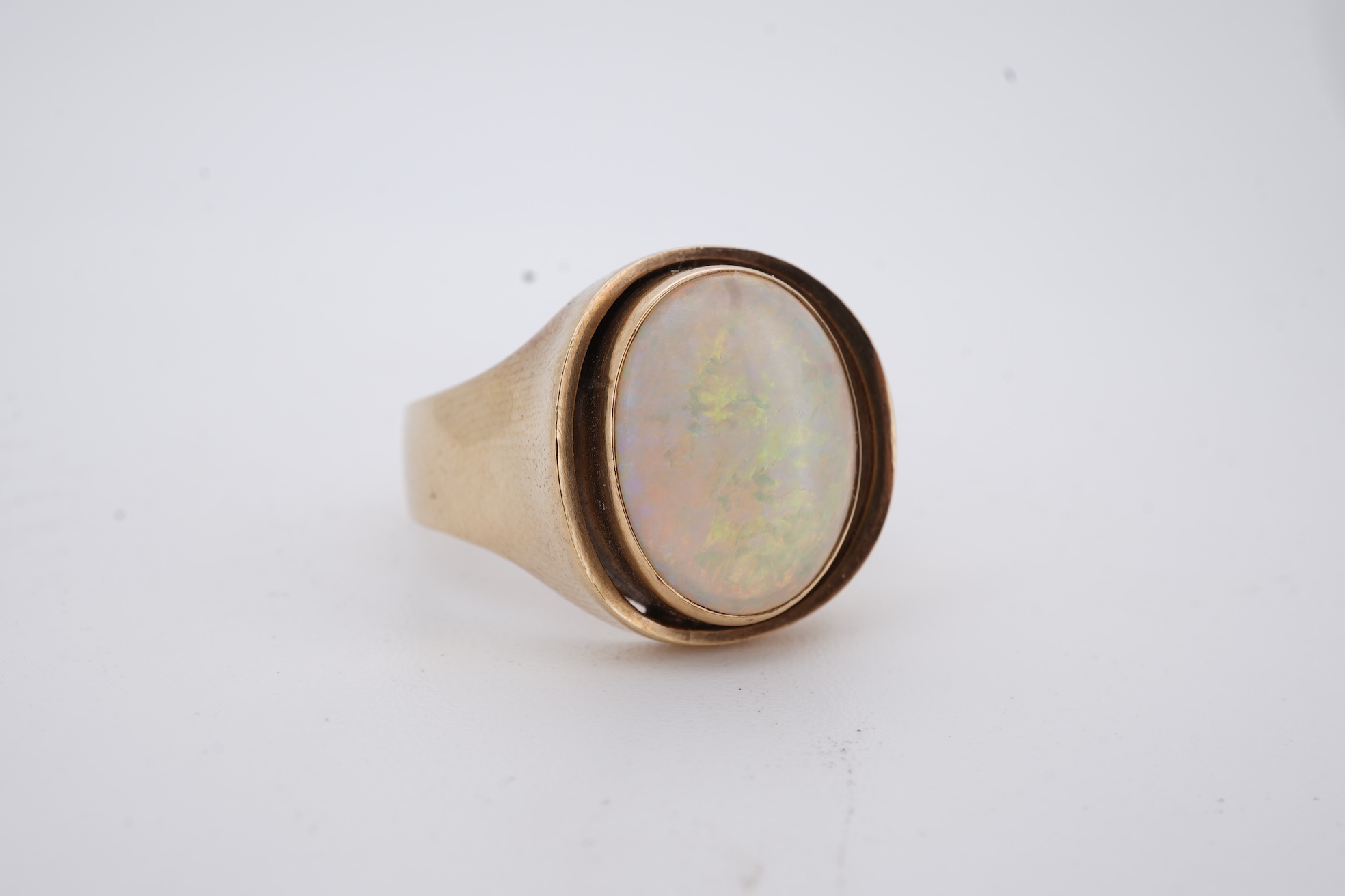 A 9ct and single stone cabochon white opal set ring, size K/L, gross weight 5 grams.